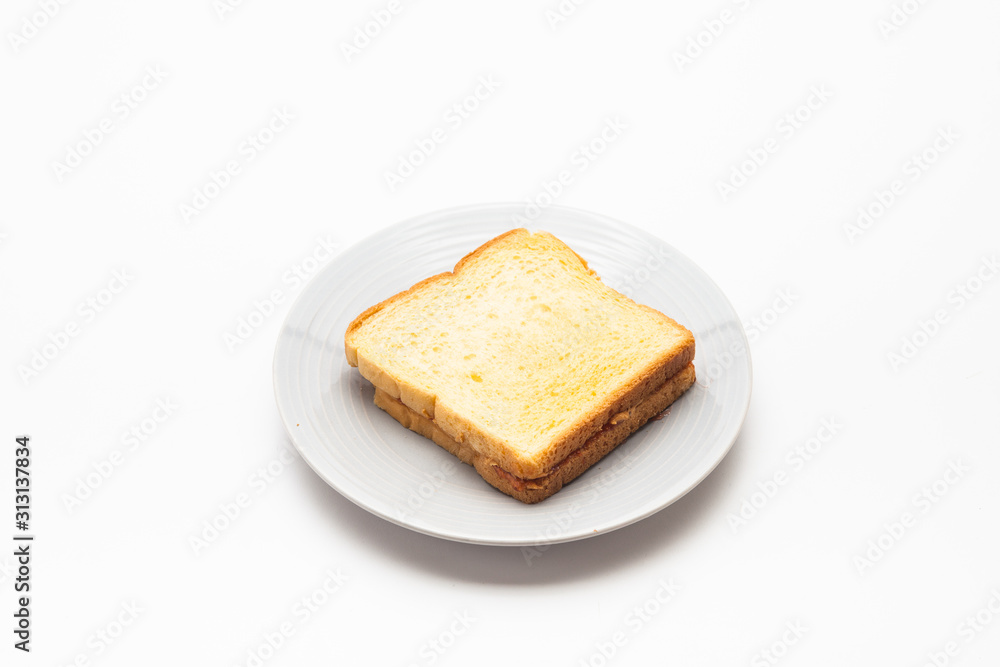 A couple of toasted slice bread with jam on a plate