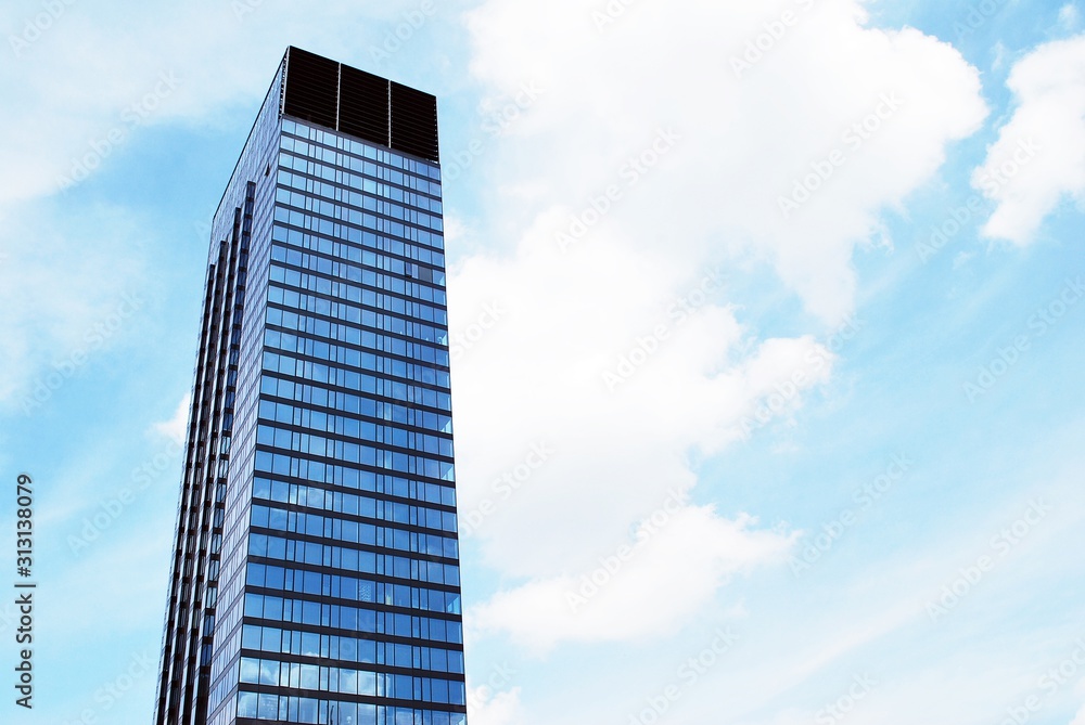Abstract image of looking up at modern glass and concrete building. Architectural exterior detail of office building. Abstract image of looking up at modern glass and concrete building. Architectural exterior detail of office building.