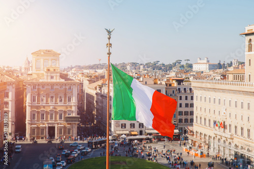 Photography National flag of Italy is developing in wind, background cityscape of Rome summe