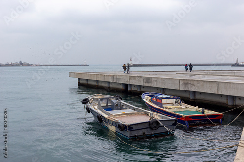 Parked boats on the sea shore in cloudy weather