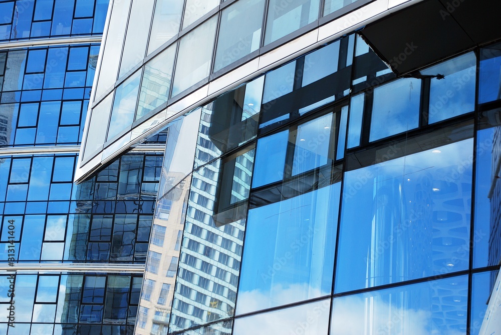 Abstract image of looking up at modern glass and concrete building. Architectural exterior detail of office building. Abstract image of looking up at modern glass and concrete building. Architectural exterior detail of office building.