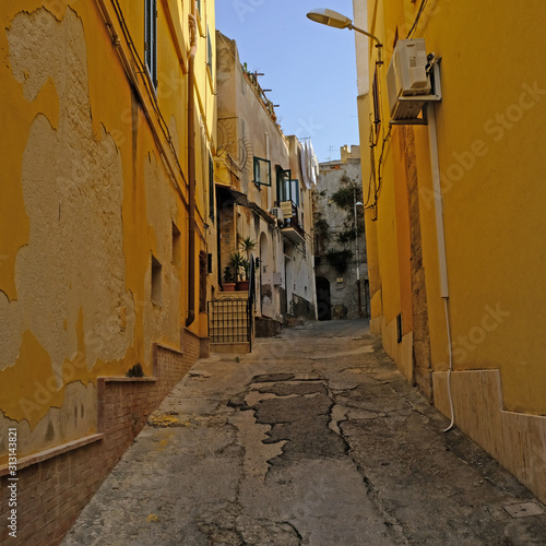 Narrow footpath cobblestone street in Sciacca, Province of Agrigento, Sicily, Italy. 09/01/2019