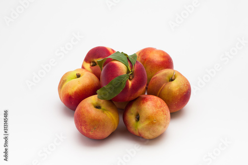 Group of ripe peaches on a white