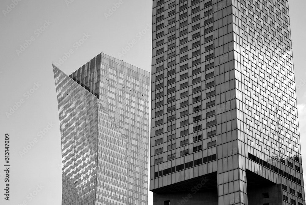 Obraz premium Abstract image of looking up at modern glass and concrete building. Architectural exterior detail of office building. 