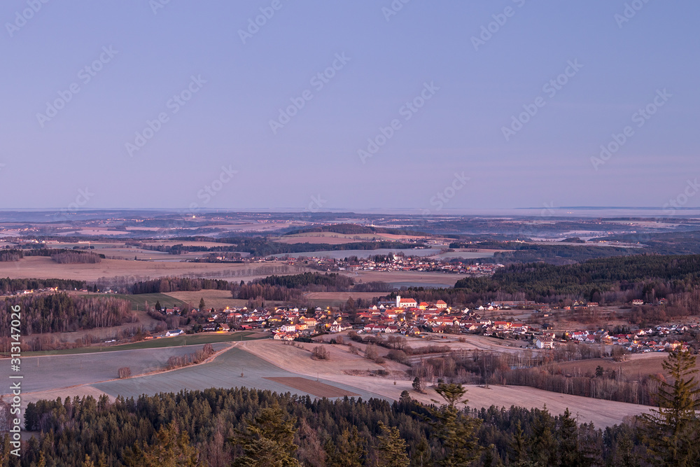 South Bohemian village with church - at night - before the dawn, rural landscape with forests, fields and meadows around (Sobenov, Czech republic) 