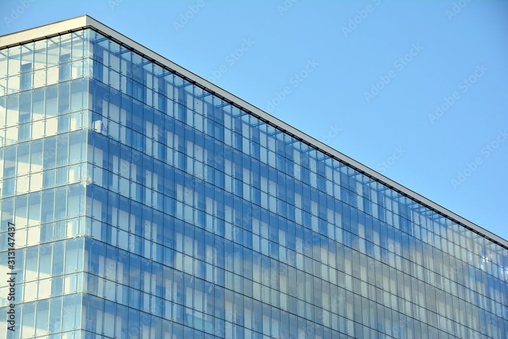Abstract image of looking up at modern glass and concrete building. Architectural exterior detail of office building. Abstract image of looking up at modern glass and concrete building. Architectural exterior detail of office building.