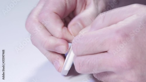 Remove suppository from packaging with male hands