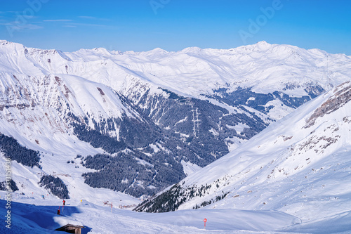 Panorama of Hintertux Glacier ski resort in Tyrol in Mayrhofen in Zillertal valley in Austria in winter Alps. Panoramic landscape in Hintertuxer Gletscher in Alpine mountains. White snow, blue sky