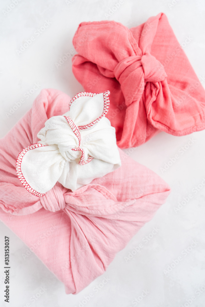Furoshiki - Asian technique of fabric wrapped gifts. The linen cloth is knotted traditionally used to transport gifts. Furoshiki - Asian technique of fabric wrapped gifts. The linen cloth is knotted traditionally used to transport gifts.