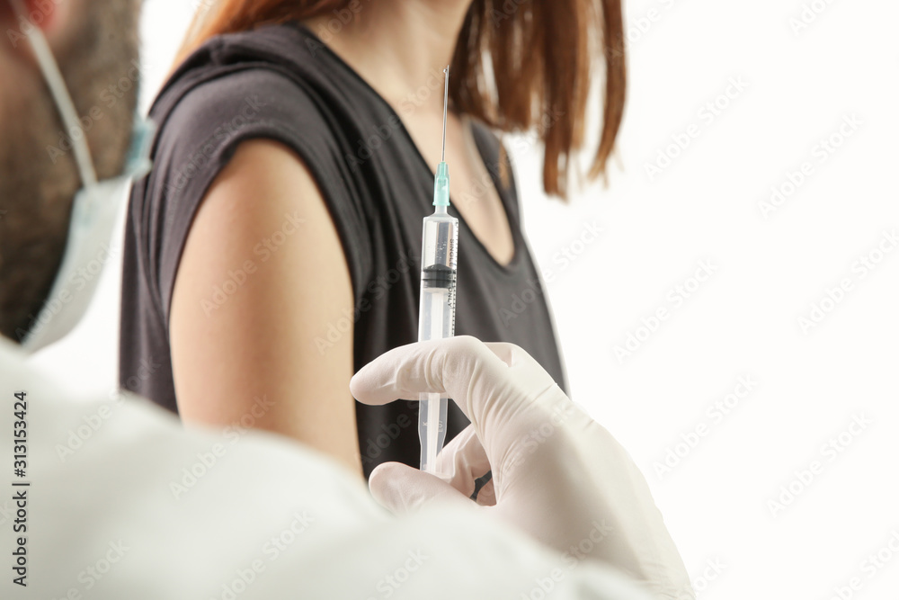 Doctor giving patient vaccine, flu or influenza shot