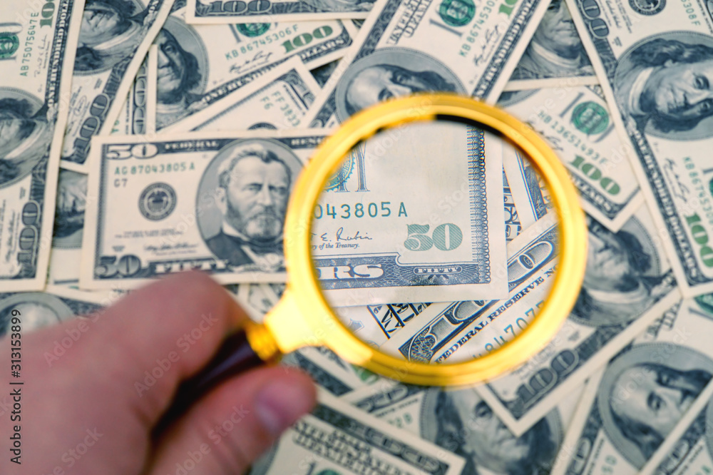 Fifty dollars banknote under magnifier.