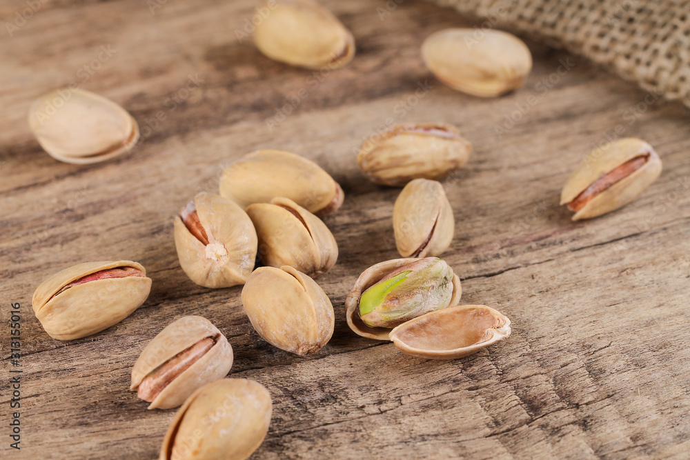 Group of pistachios on a wooden table. Healthy food. Group of pistachios on a wooden table. Healthy food.
