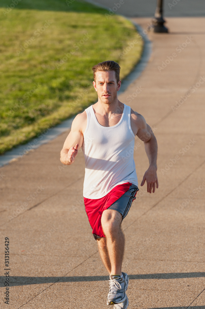 Caucasian man jogging outdoors in the early morning