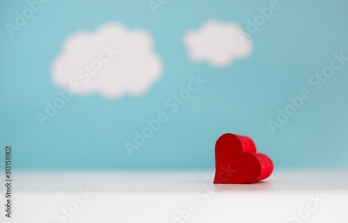 Isolated heart on blue sky  and cloud background. 