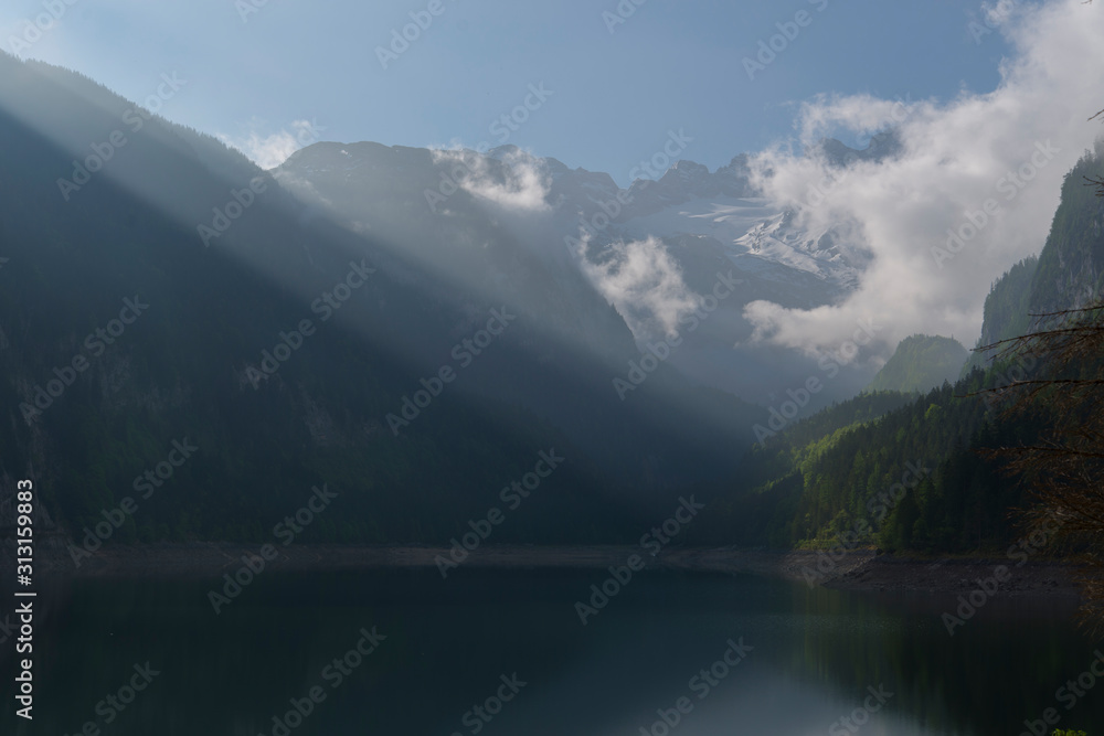 sun beams on dachstein glaciers and lake gosau