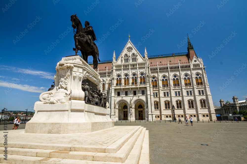 statue of Count Gyula Andrassy in front of Hungarian Parliament Building, landscape.