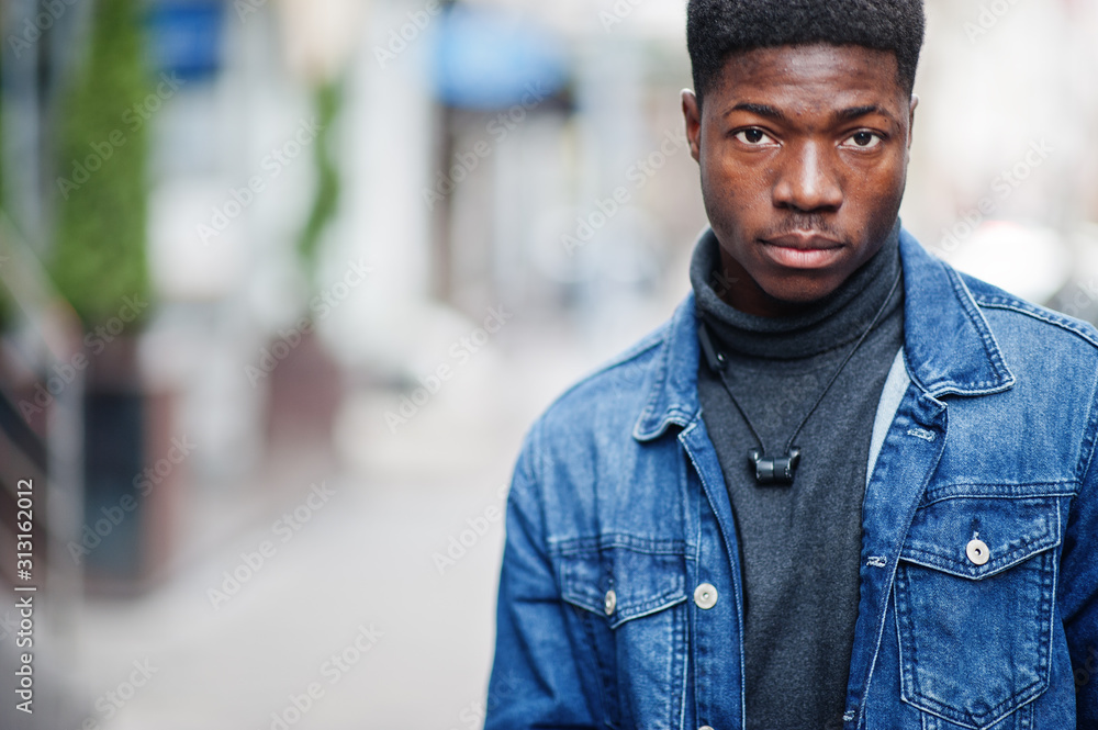 Close up portrait of african man wear on jeans jacket posed outdoor. Close up portrait of african man wear on jeans jacket posed outdoor.