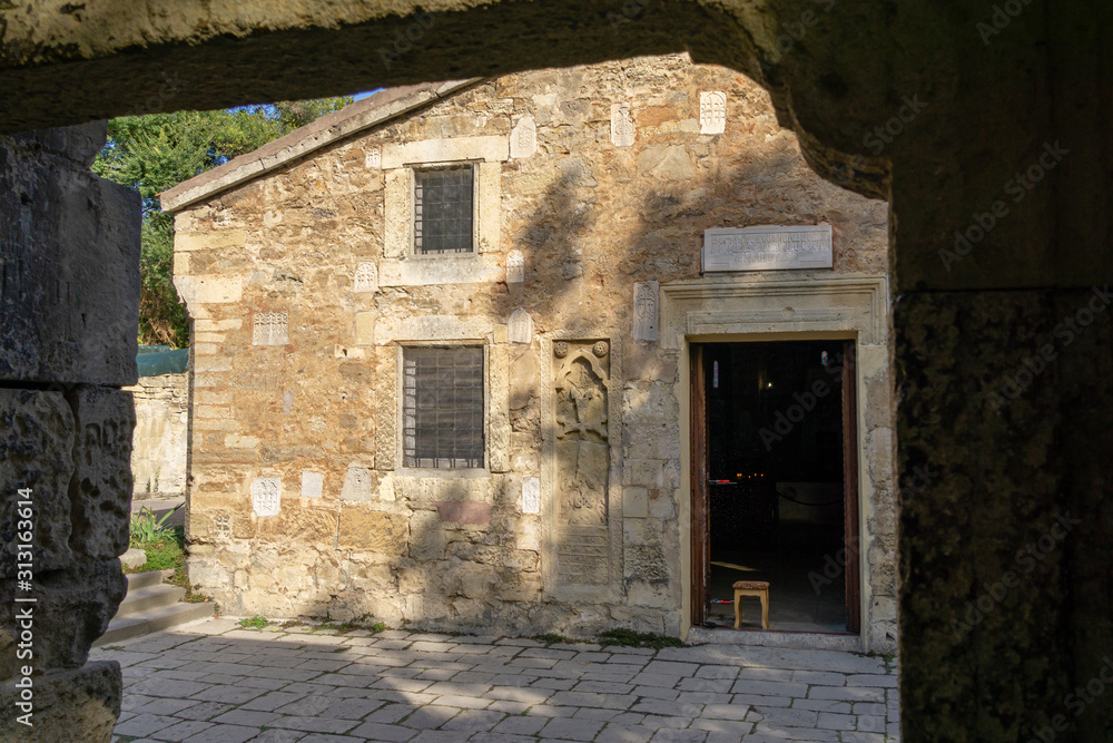 Fototapeta premium Feodosia, Crimea, Russia - September 26, 2019: Medieval Armenian Church of St. Sergius (Surb Sarkis) - in Feodosia. The famous painter Aivazovsky was baptized, married and buried here.