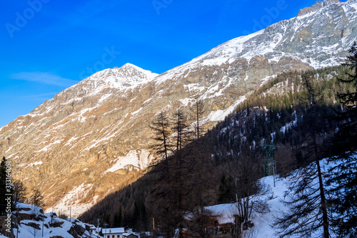 alpine panorama  snowy mountains with blue sky
