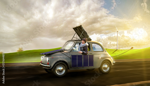 Frau fährt in Ihrem Elektroauto übers land und lädt diese mittels Solarpanels