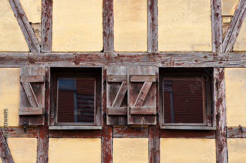 Windows and wall of old half-timbered house.