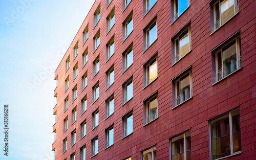 Apartment in residential building exterior. Housing structure at blue modern house of Europe. Rental home in city district on summer. Architecture for business property investment in Berlin, Germany.