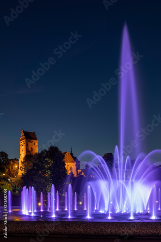 Wallpaper Mural Poland, Warsaw, Purple fountain in Multimedia Fountain Park at night with Saint Marys Church in background Torontodigital.ca