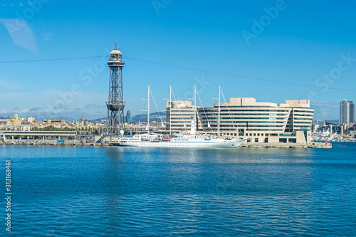 Cruise Port with a tower Torre Jaume I, World Trade Center Barcelona, Hotel Eurostars Grand Marina and a yacht Wind Star in Barcelona