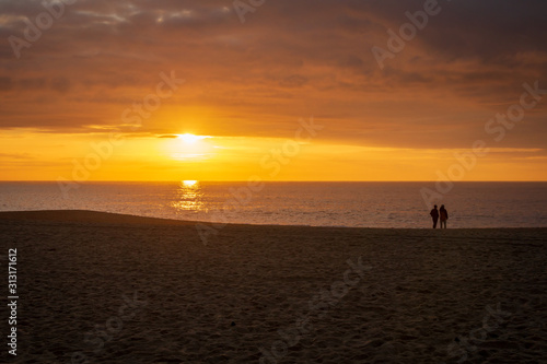 Couple seeing the sunset at the beach © WildGlass Photograph