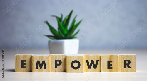 empower word written on wood block. empower text on table, concept. photo