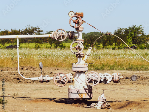 Well for oil and gas production. Oil well wellhead equipment. Oil production photo