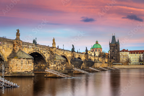 Prague, Czech Republic - The world famous Charles Bridge (Karluv most) with a beautiful purple sky and sunset on a winter afternoon © zgphotography
