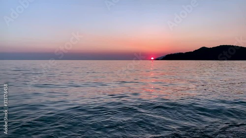 Beautiful sea sunset footage. Mountains near ocean. Summer vacation concept