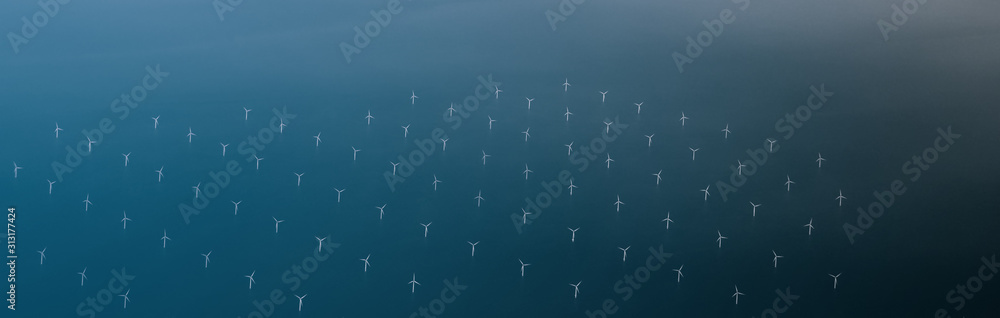 Windmills at the sea. Clean energy made by the wind. Photo in bird perspective. Offshore wind farm. - obrazy, fototapety, plakaty 