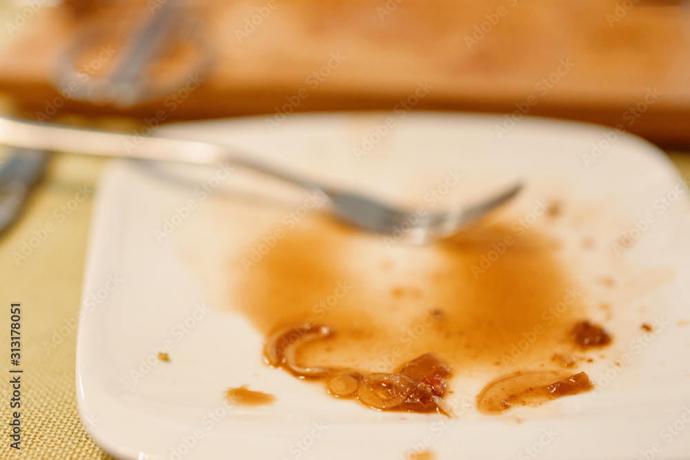 Dirty plate. Food stain left after eat on white dish. Dirty plate. Food stain left after eat on white dish.