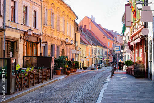 Obraz na płótnie Street cafes with tables and chairs in Ptuj old town center in Slovenia. Architecture and restaurants in Slovenija. Travel w salonie
