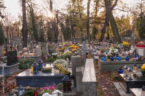 Many candles are lit, many flowers decorate the tombstones on All Saints Day