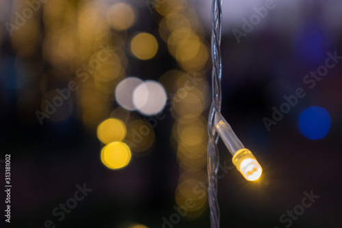 Colorful light bulbs on a bokeh background.