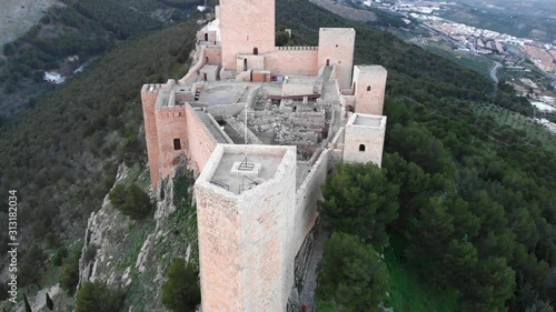 Jaen's Castle Saint Catalina Castle Spain shoot with a drone at 4k 24fps showing the exterior and the city from multiple points on a afternoon in December. photo