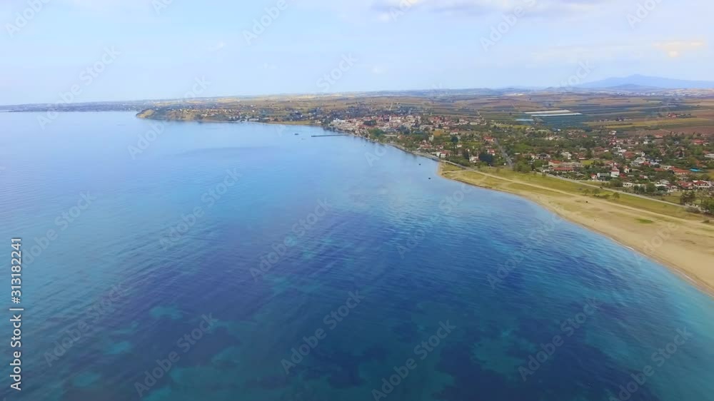 Empty sandy spacious beach and sea with different shades of blue color. Aerial drone footage