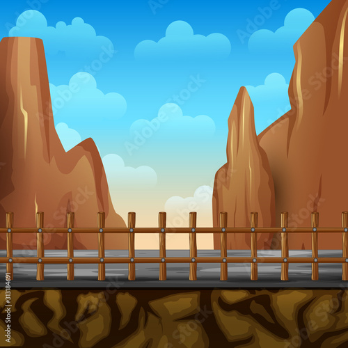 Scenery of a road fences and cliff with mountains cliff