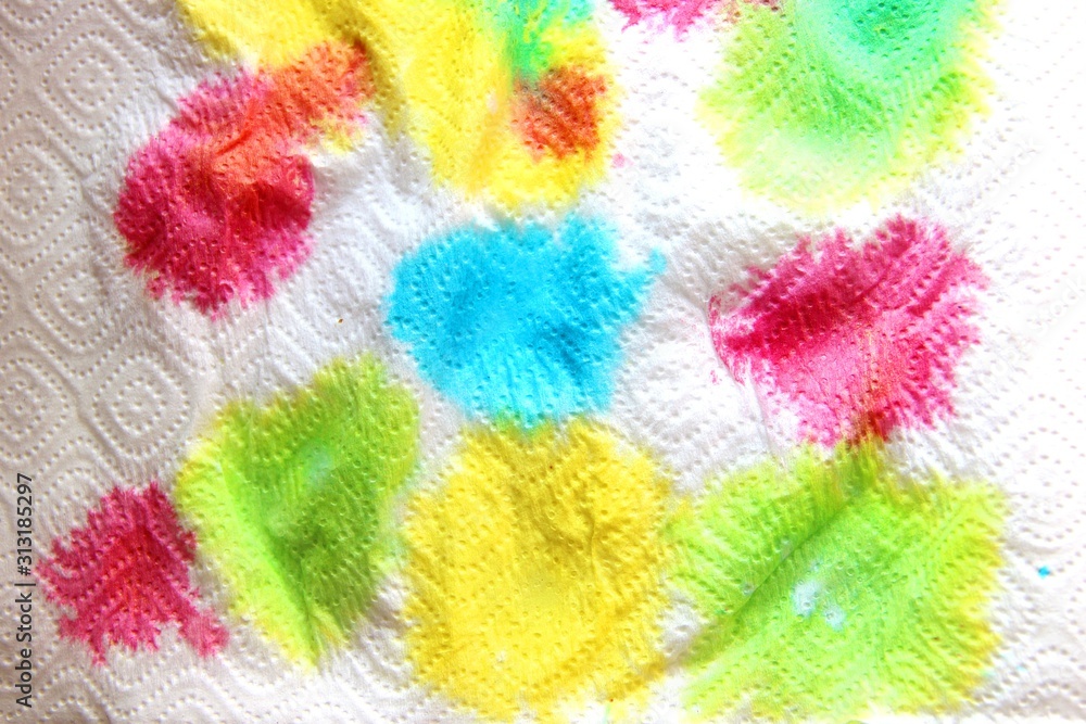 abstract background, blue, yellow, red, green blurring. multicolored bright paint stains on a white paper napkin.