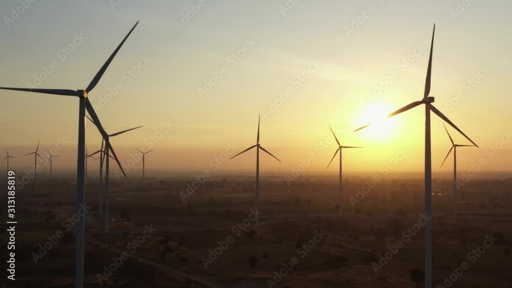 Aerial view of Wind turbines of save Energy save world in video 4k format. aerial shot on sunset. drone footage wind turbines at sunrise with beautiful clouds. Global warming concept and green energy. Aerial view of Wind turbines of save Energy save world in video 4k format. aerial shot on sunset. drone footage wind turbines at sunrise with beautiful clouds. Global warming concept and green energy.