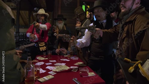 The sheriff and cowboys relax, drink and play cards at the saloon the sheriff deputy noticed a cowboy cheating The sheriff and his assistant drew a gun and threatened. Finally the sheriff fired a gun.