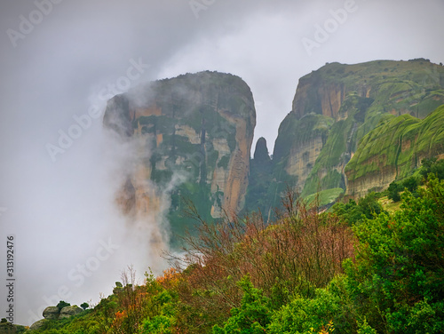 Meteora  Greece  winter dramatic landscape with heavy clouds and foggy mountains. Vibrant colorful nature.