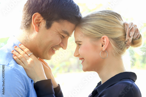 Fényképezés Sweet couple showing love by touching heads in park, young beautiful woman puts