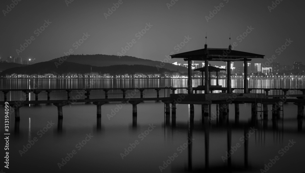 Night view of Chinese Pavillion and Chinese bridge with light decoration at East Lake Wuhan, Hubei, China Night view of Chinese Pavillion and Chinese bridge with light decoration at East Lake Wuhan, Hubei, China