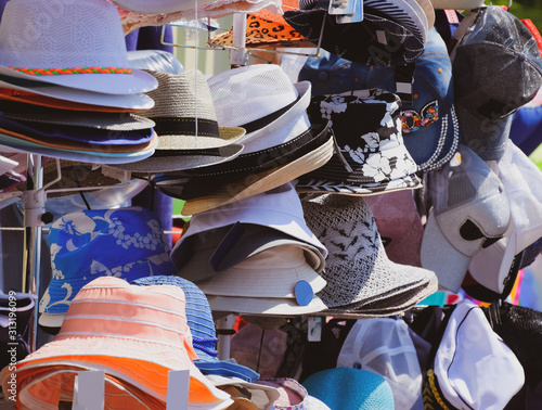 Canvas-taulu Hats from the sun. Hats in the market are sold in a shop