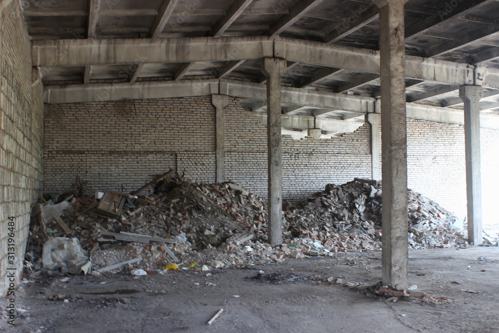 Abandoned dirty warehouse storage area, old industrial building indoor view