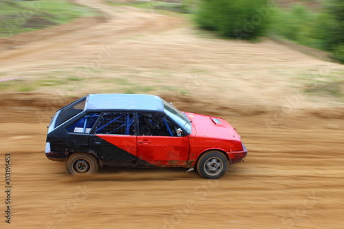 Russian front wheel drive red black racing car on off road racing closeup, auto cross competition © Ilya